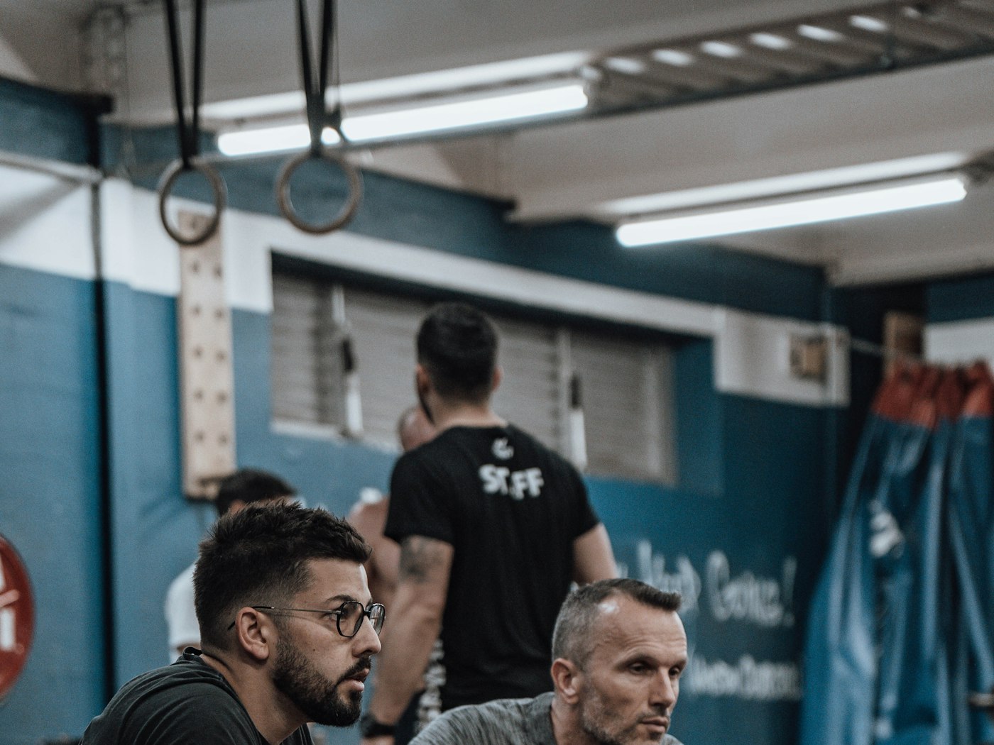 Two members in conversation on the gym floor between training sets
